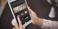 Alt text: Ein Smartphone mit Casinospielen auf dem Bildschirm.