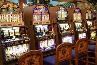 Eine Reihe von gleichen Spielautomaten in einem Casino.