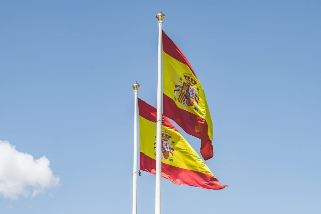 Zwei spanische Flaggen an Fahnenmasten.