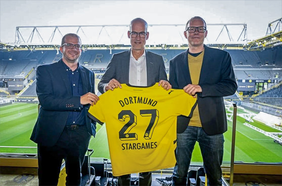 StarGames-Logo neben dem Borussia Dortmund-Logo, symbolisierend die neue Premium-Partnerschaft.